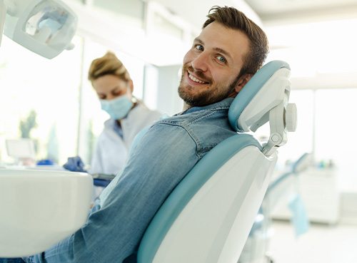 Patient smiling while sitting in treatment chair