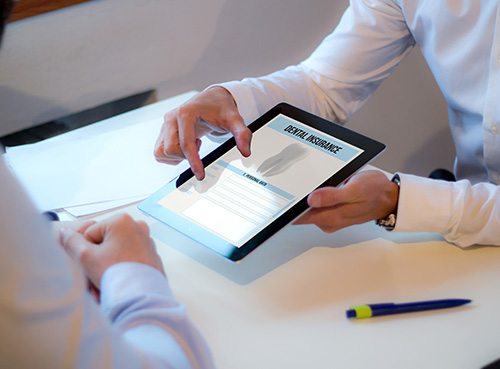 Patient reviewing dental insurance form on tablet