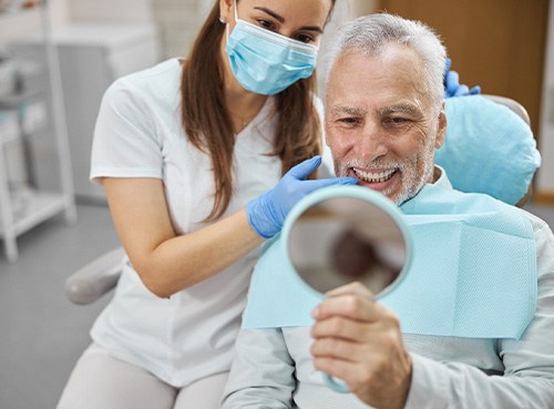 A man smiling at his new teeth