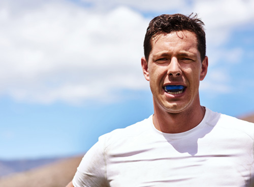 Man wears athletic mouthguard