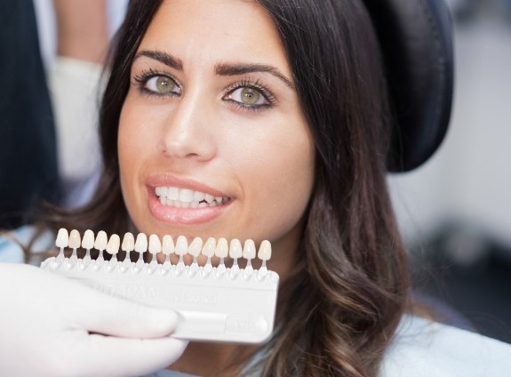Woman smiling with a row of veneer from her cosmetic dentist in Santa Clarita