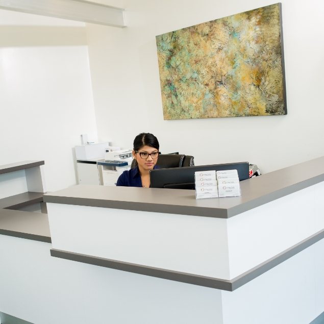 Dental team member sitting at front desk