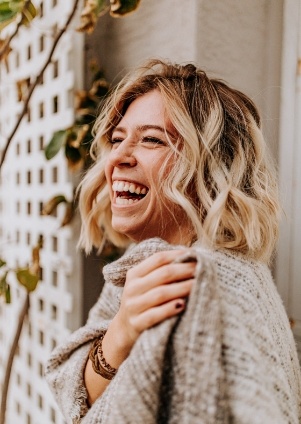 Laughing woman in off white sweater