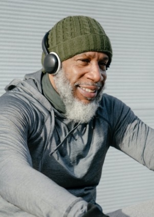 Older man wearing beanie and headphones
