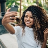 Young woman taking selfie outdoors