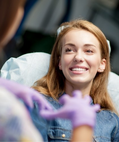 member of dental staff smiling with patient