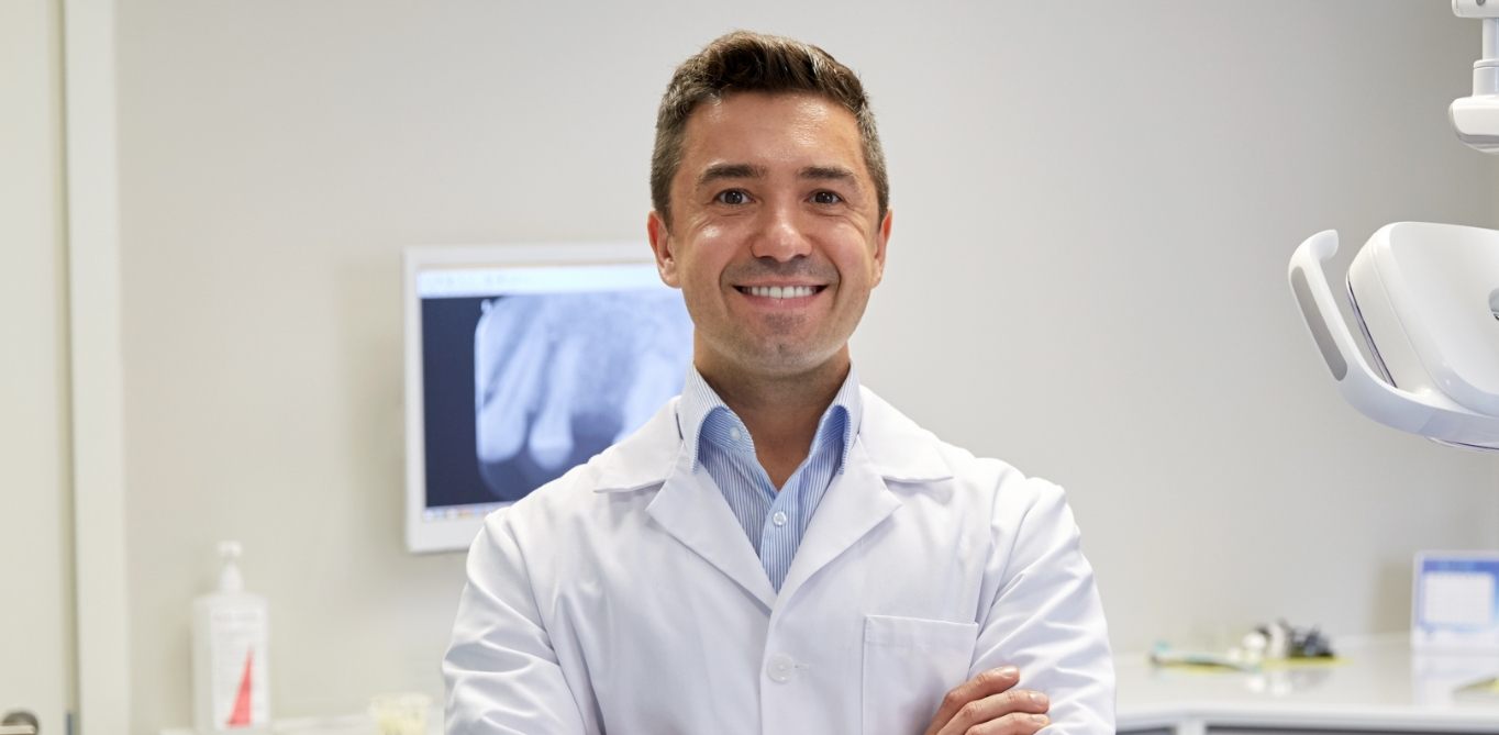 Santa Clarita childrens dentist smiling with arms crossed