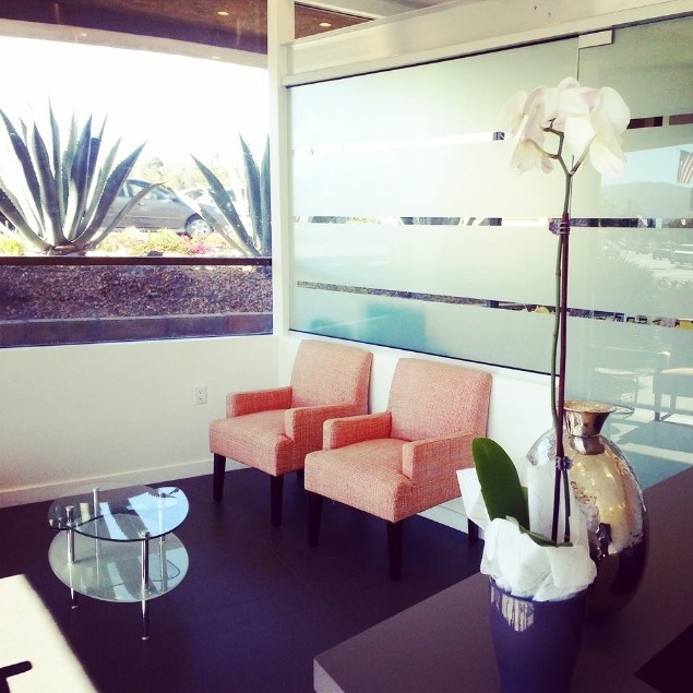 Two light orange armchairs in dental office reception area