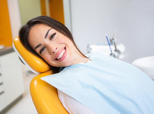 Woman smiling while relaxing in treatment chair