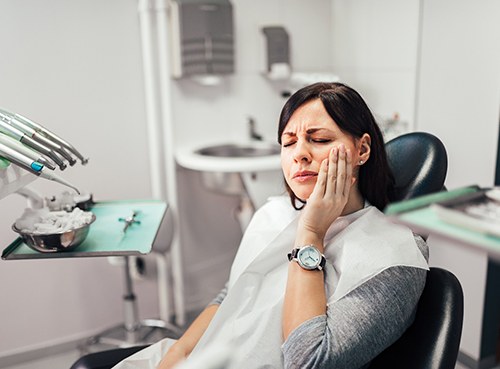 Woman with toothache at dentist's office