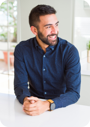 Man in dark blue button up shirt sitting at table