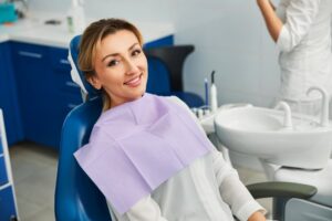 Woman smiling after getting her dental crown fixed